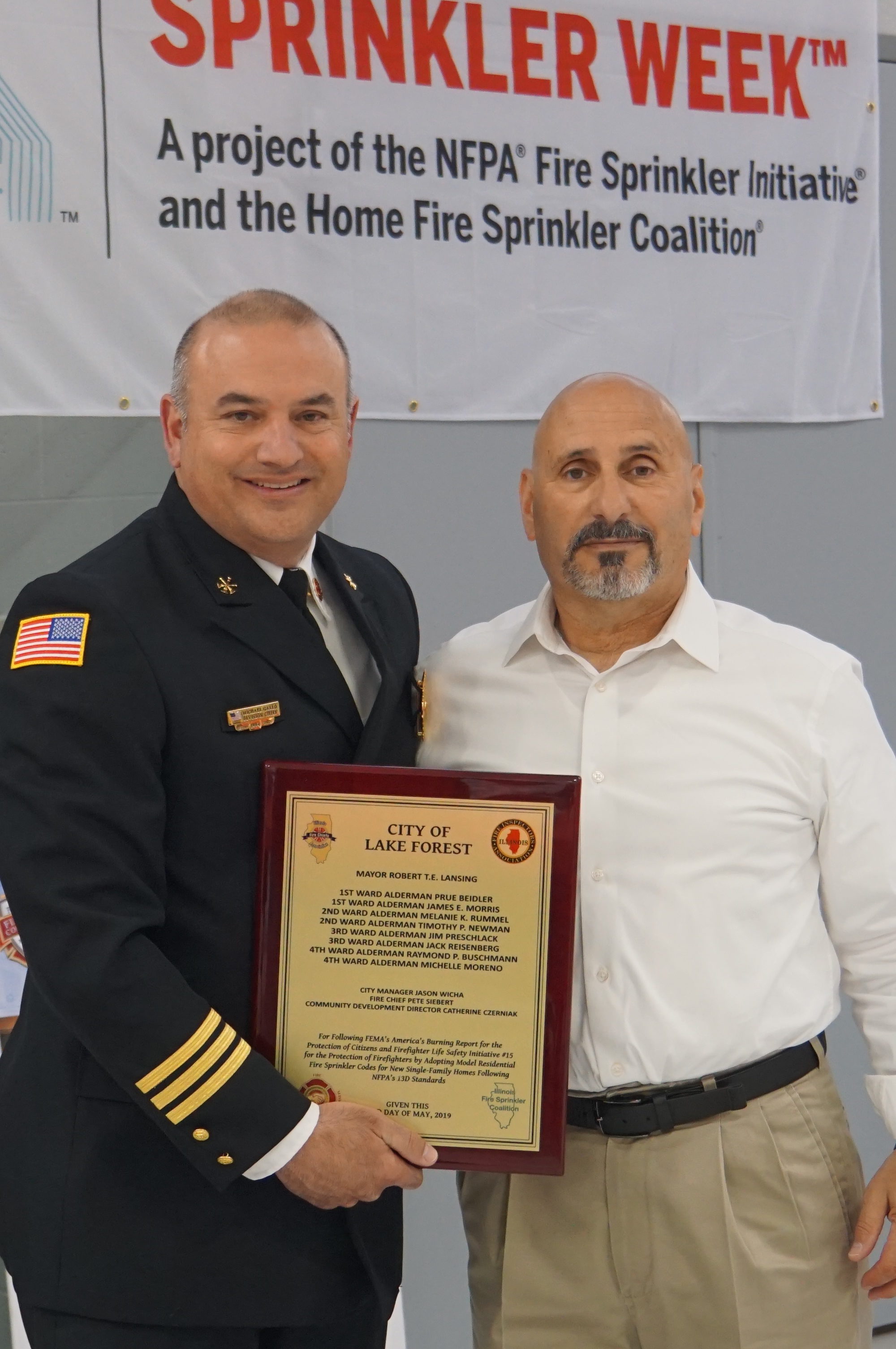 Lake Forest Fire District recognition award presented to Fire Chief Pete Siebert by Steve Iovinelli of the Illinois Fire Services Association.
